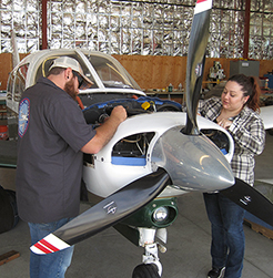 people working on an airplane