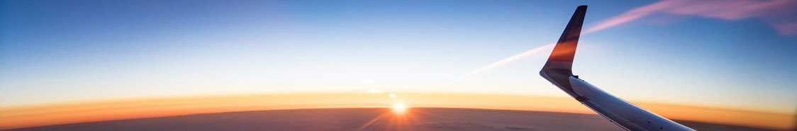 Airplane flying in morning sky