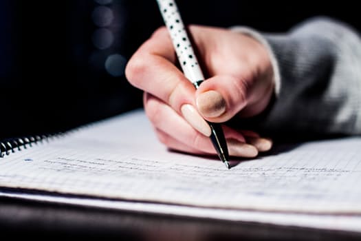 student studying with pen and paper