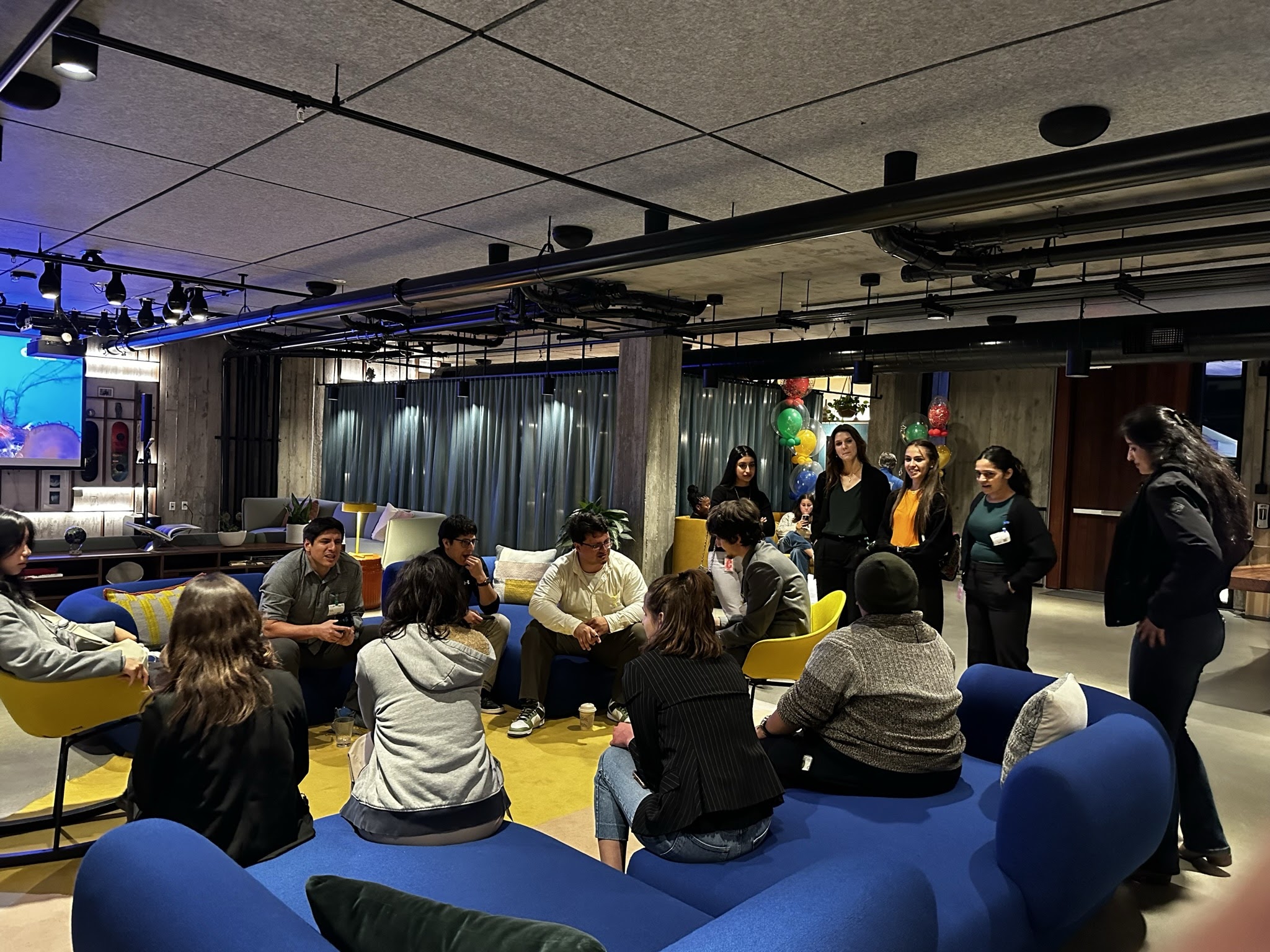 An image of students and instructors chilling on some comfy chairs.