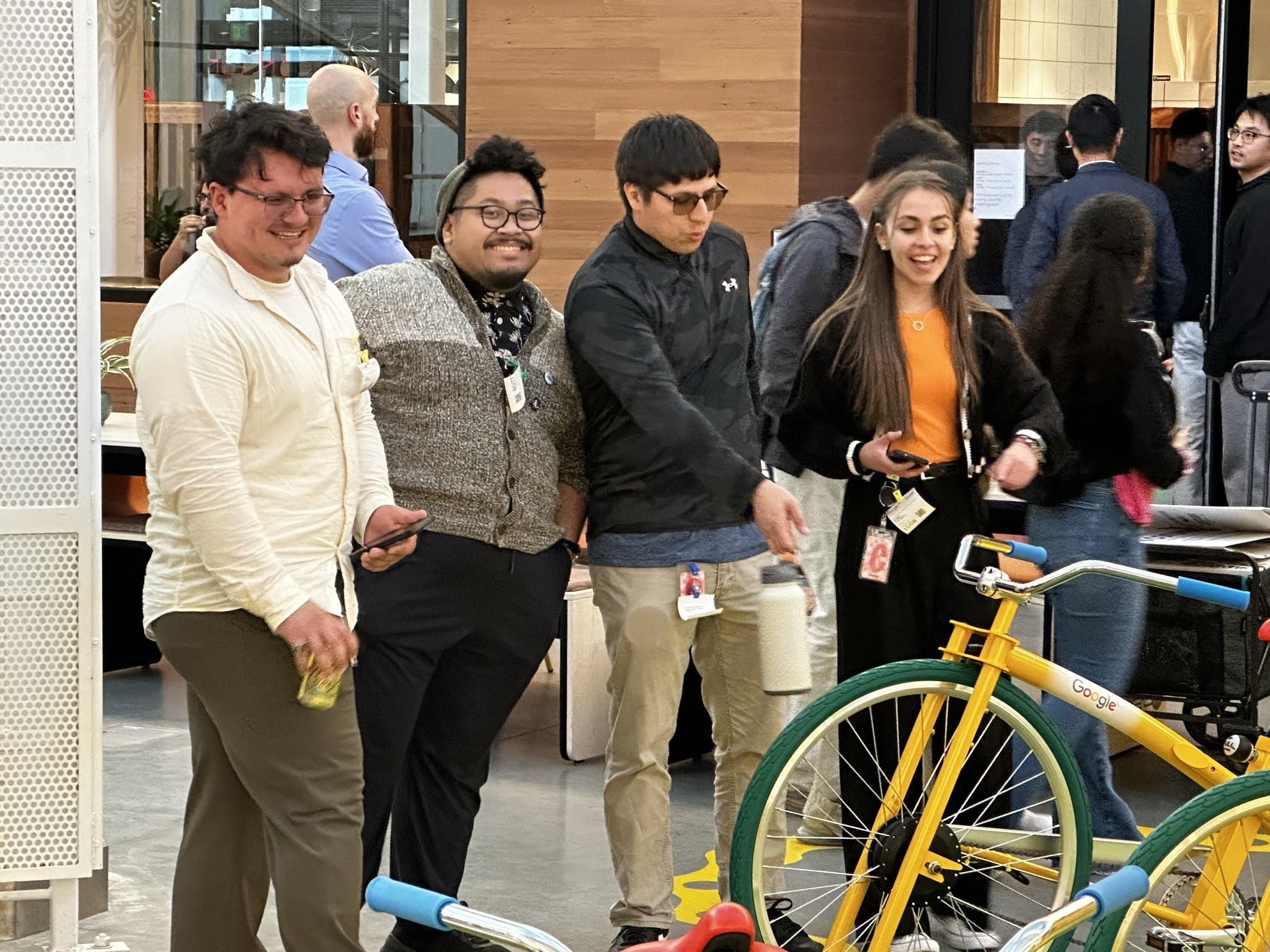 An image of a group of students reacting to the Google themed bikes.