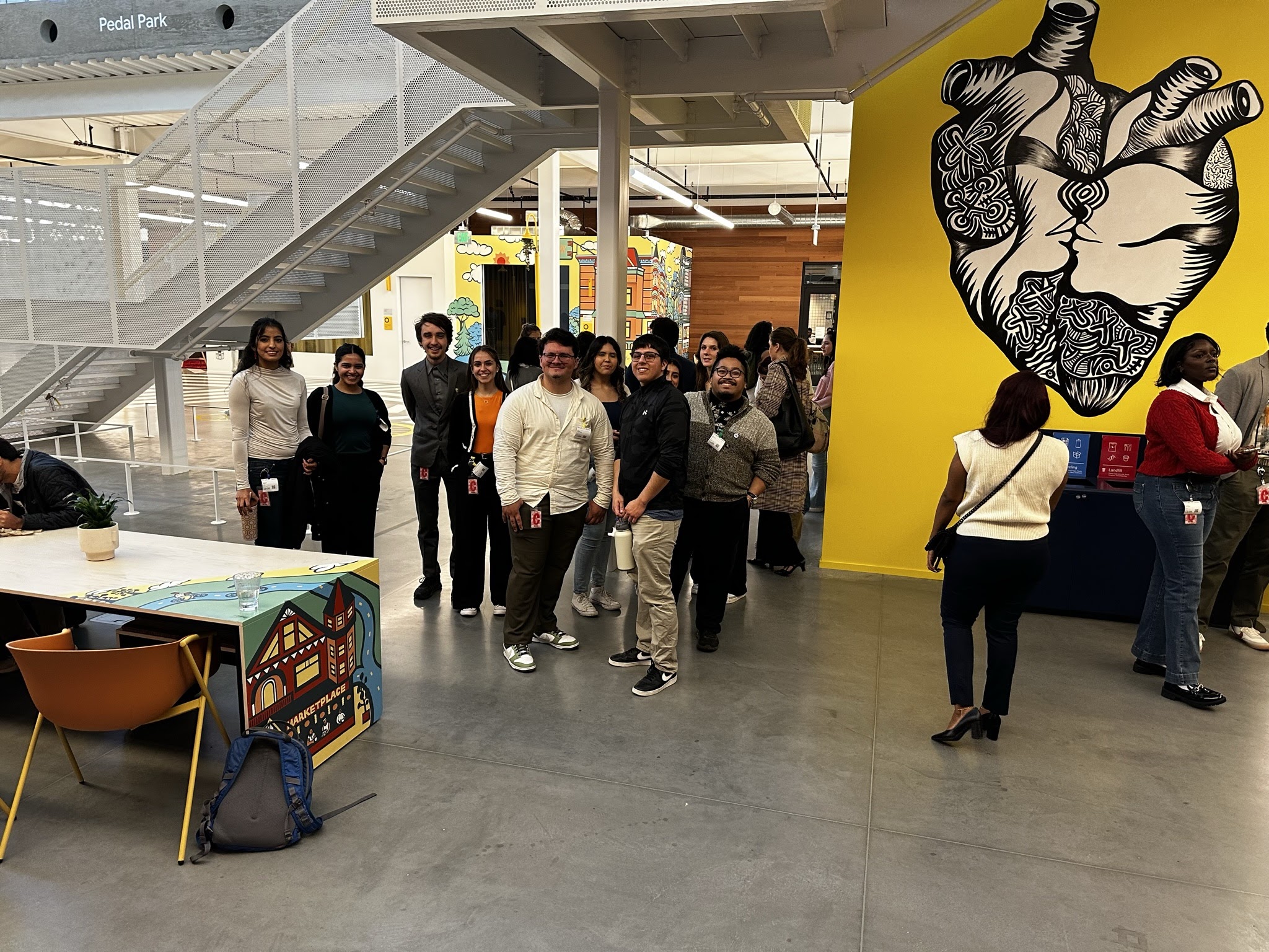 An image of students in front of art at the Google campus.