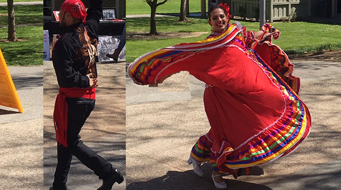 two dancers in ethnic folklorico dress dancing