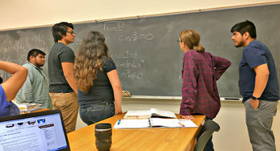 An image of a group of students helping each other