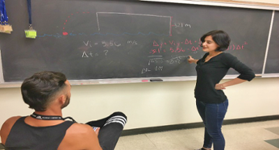 An image of a tutor working with a student in the workshop