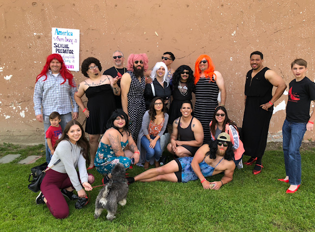 Group of student veterans pose in heels and dresses for Walk-A-Mile in Her Shoes fundraiser