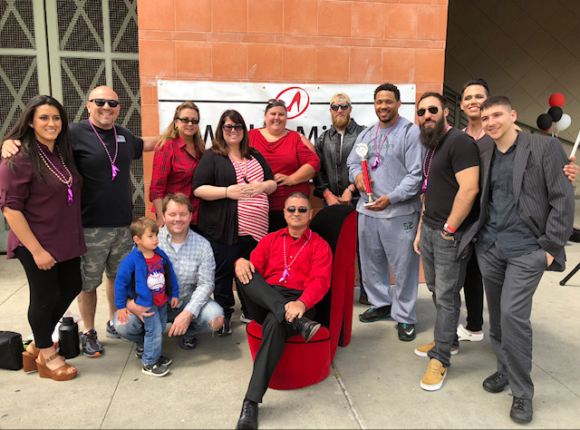 Group of student veterans pose with organizers of the Walk-A-Mile in Her Shoes fundraiser