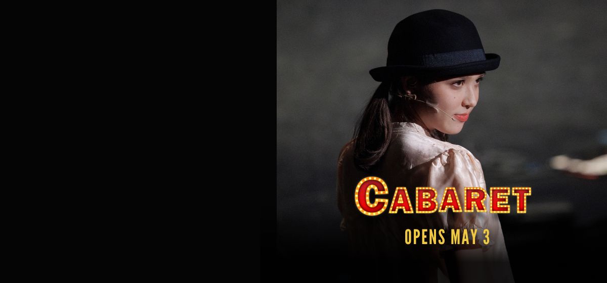 Female wearing black top hat.  "Cabaret opens May 3"