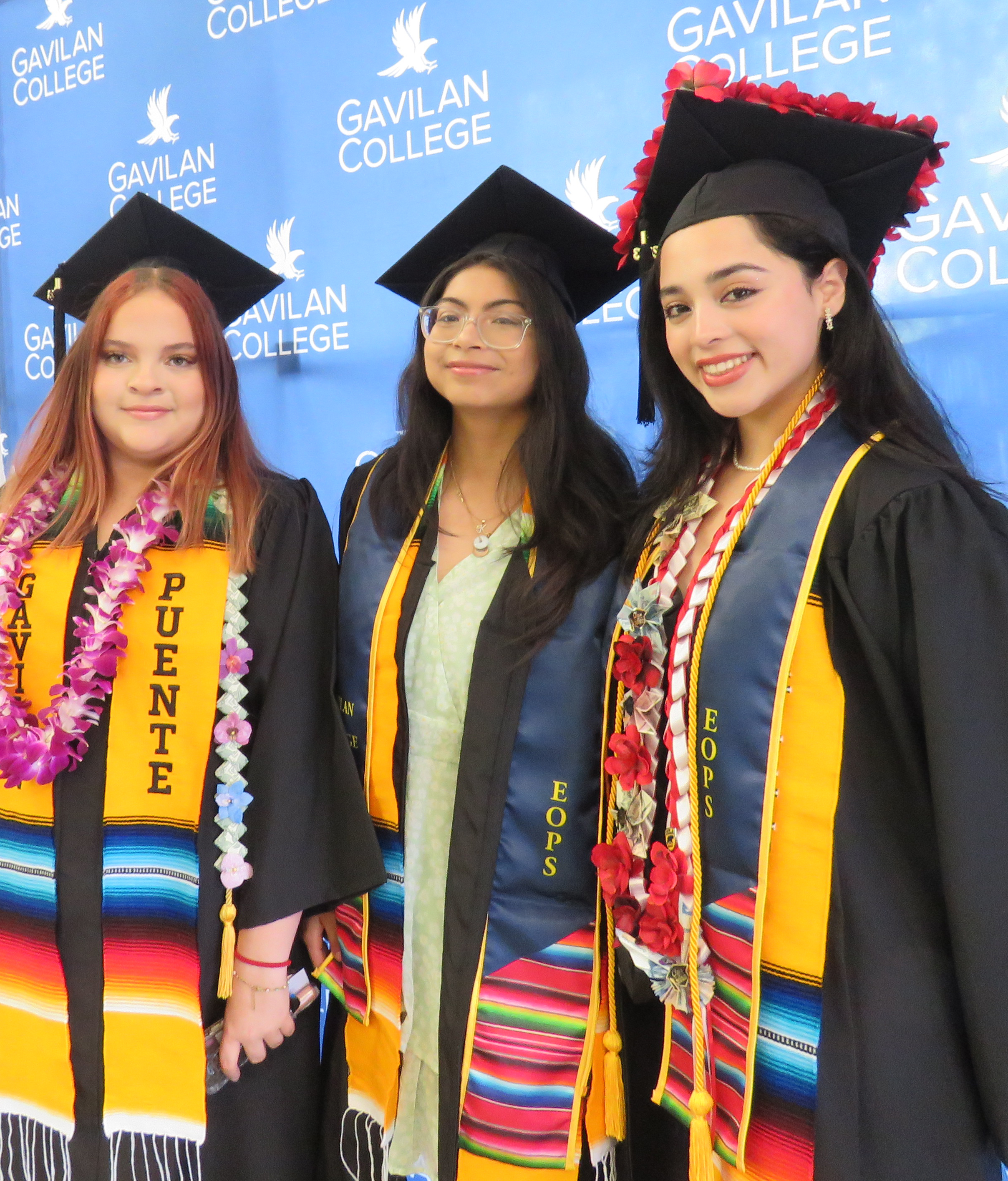 Three Latina Graduates Smiling