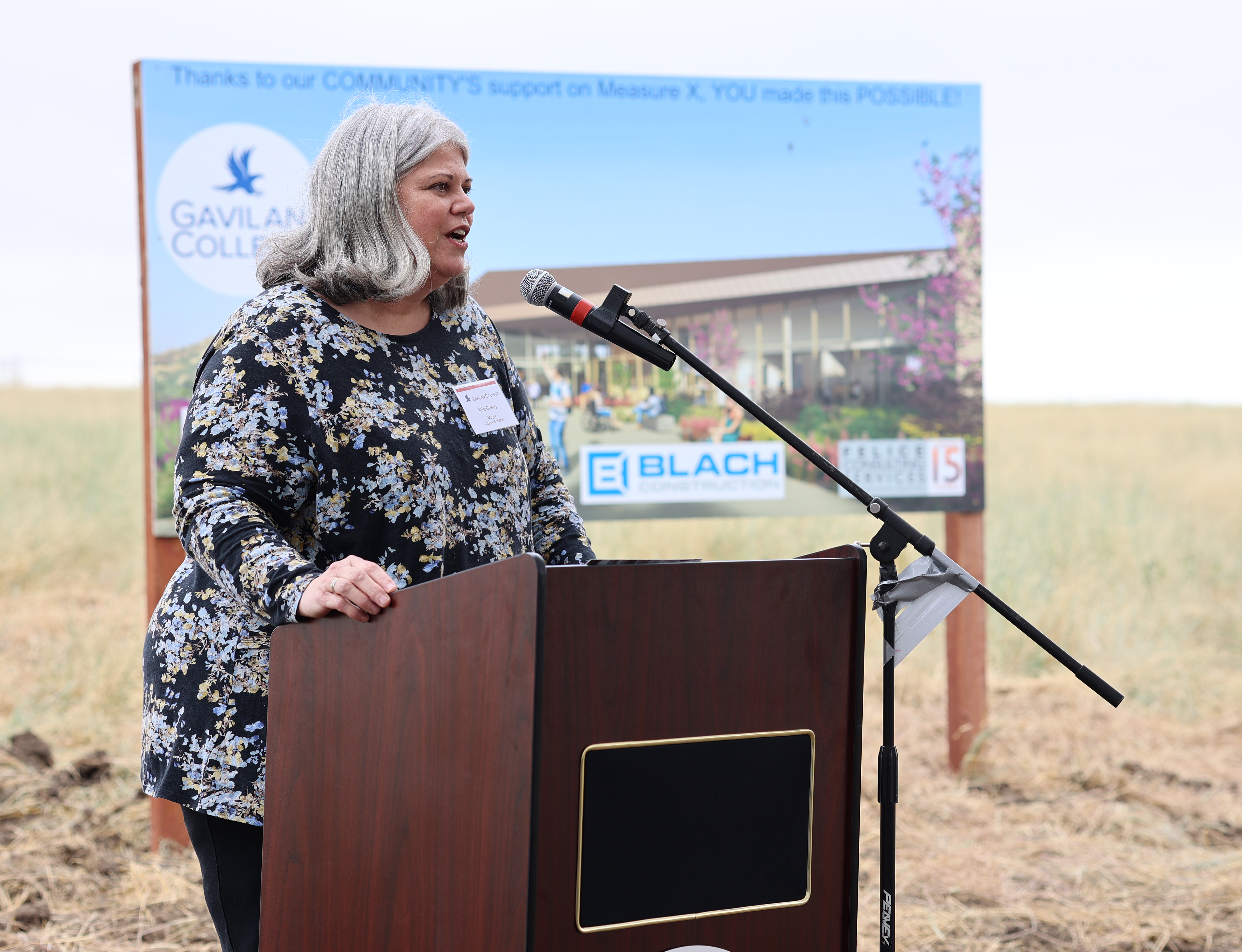 Mia Casey, Hollister mayor, speaking at podium.