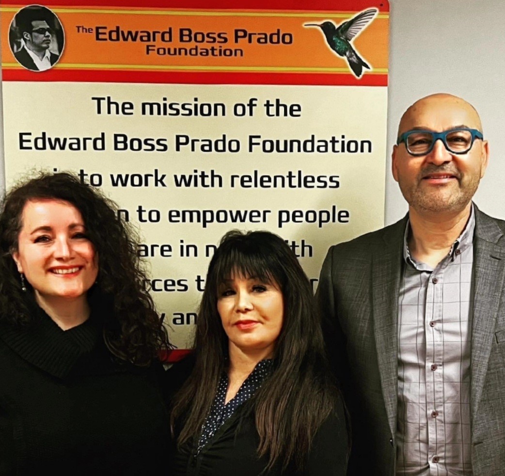 Rosie Zepeda, Cecelia Ponzini, and Dr. Pedro Avila standing in front of The Edward Boss Prado Foundation logo.