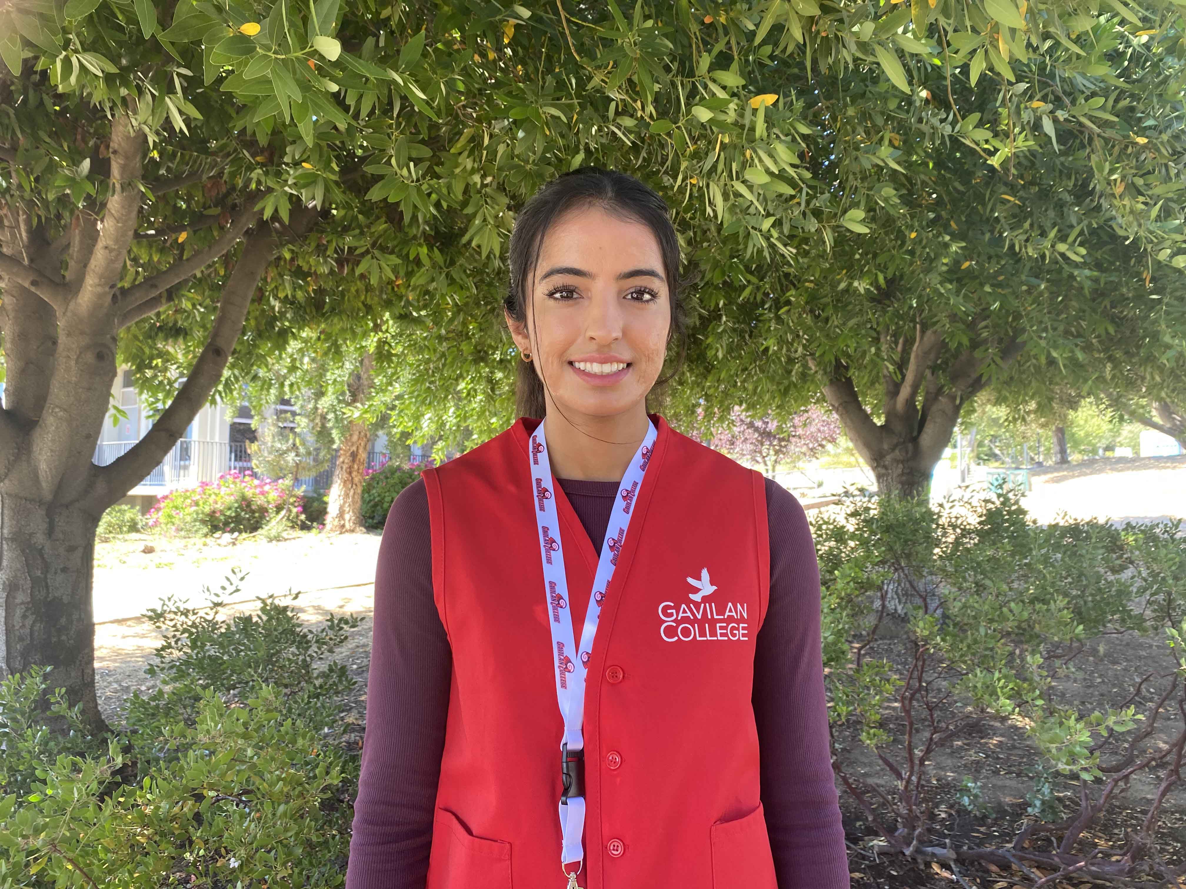 Simran wearing a red vest