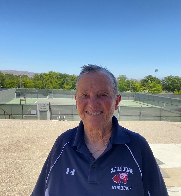 Susan Dodd standing in front of tennis courts 