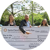 Santa Clara Family Health Plan presenting large check to Dr. Pedro Avila