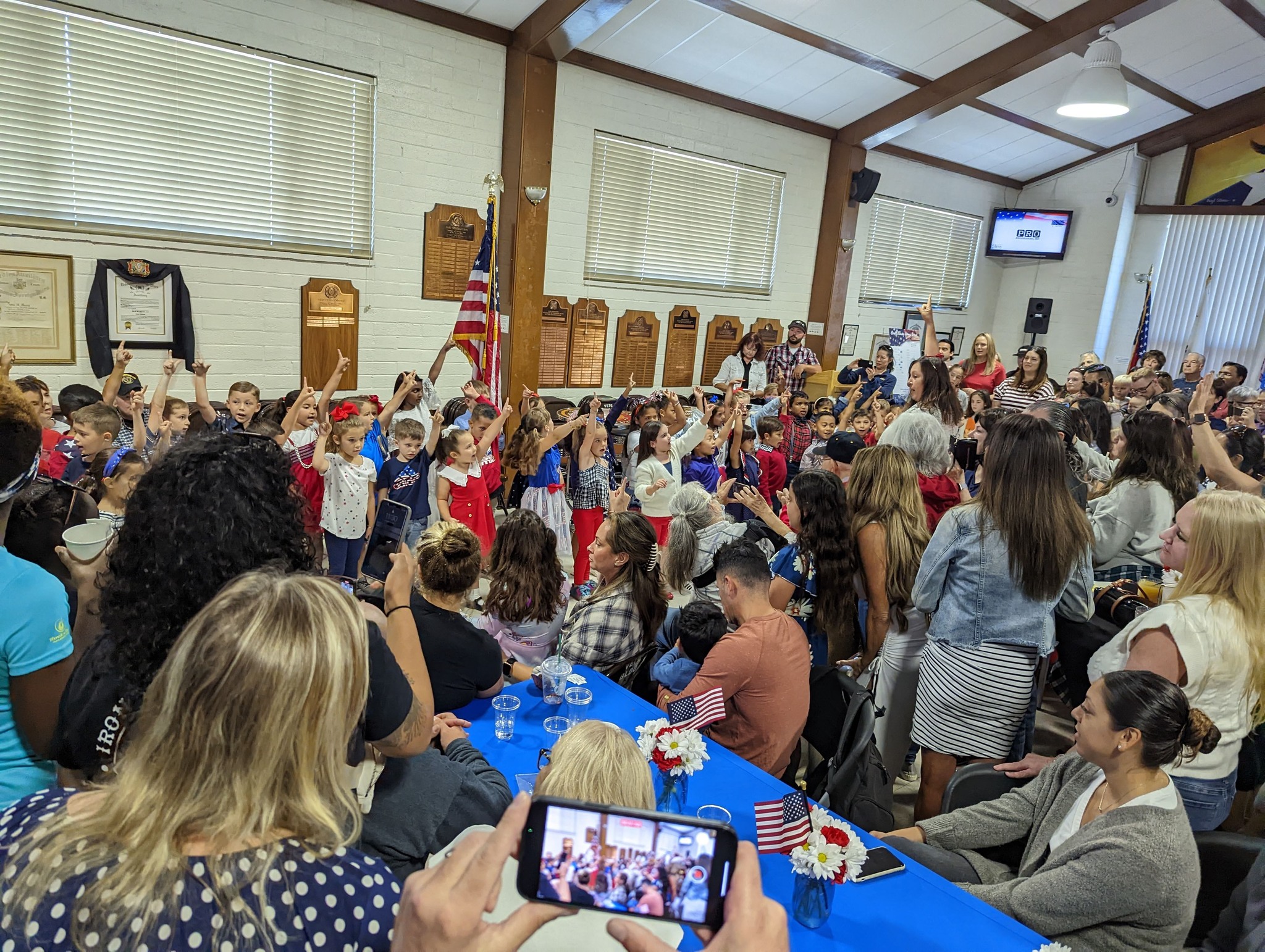 Children singing "God, Bless America" at the event.